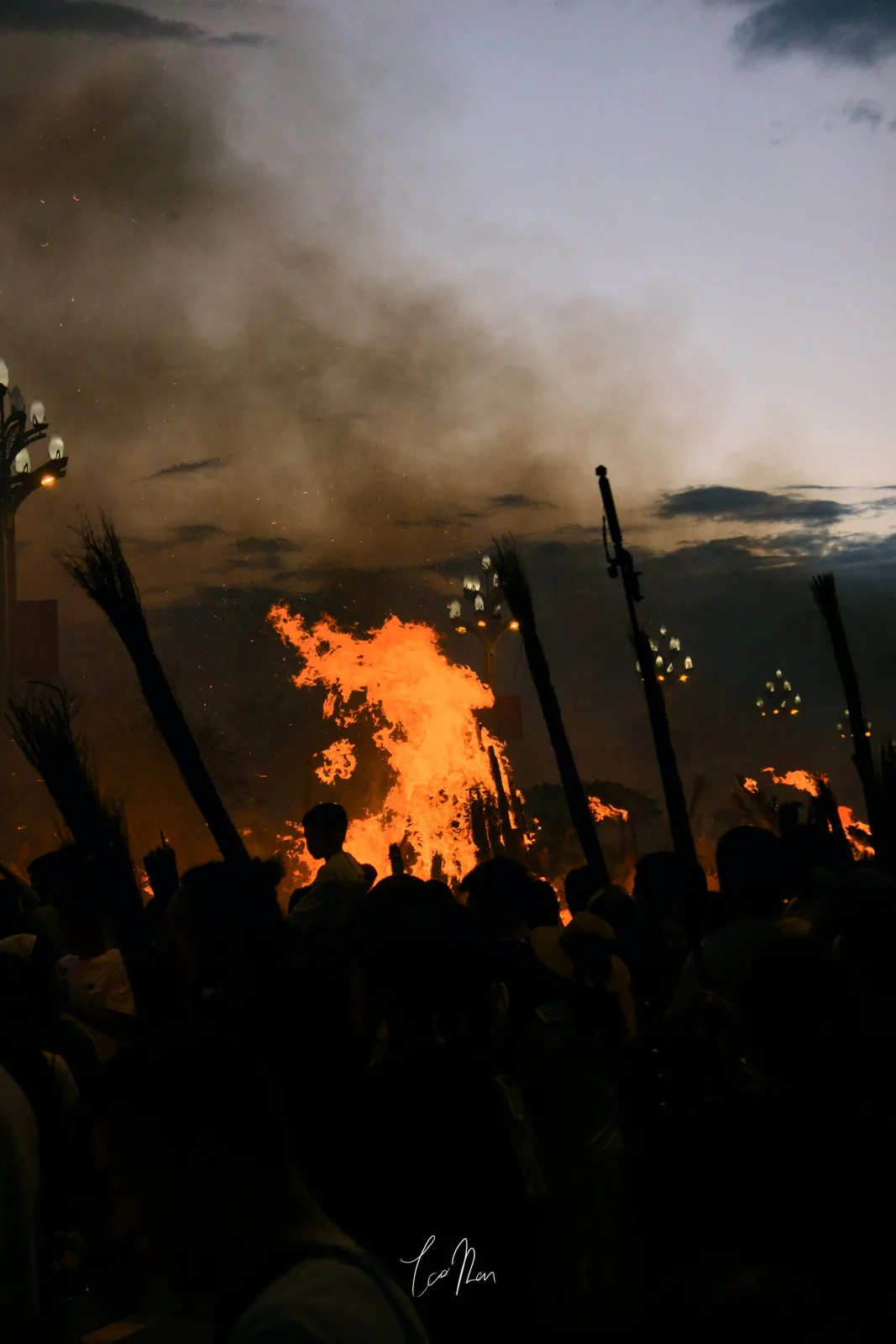 People and flames gathering at dusk